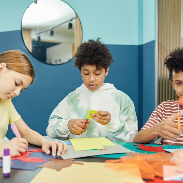 Group of diverse children learning yoga in a bright studio.